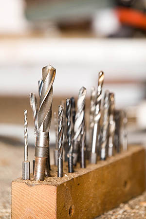 Detail of drills on workshop table, shallow focus