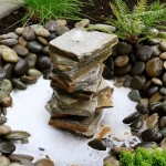 Ideas for landscaping home garden. Fountain with rocks