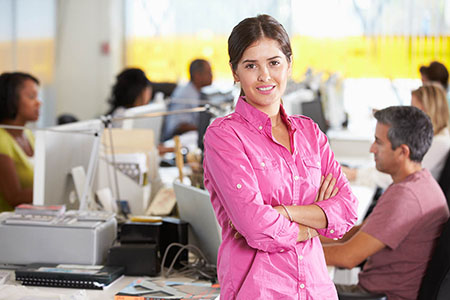Portrait Of Woman Standing In Busy Creative Office